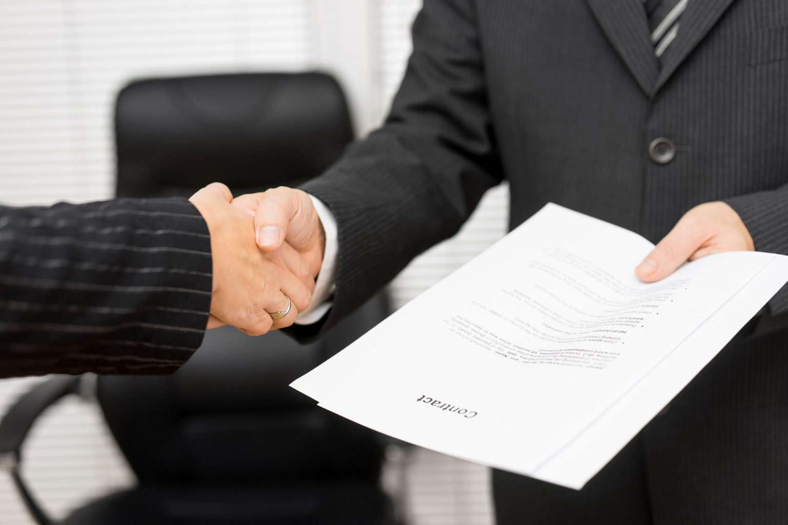 Businessman,With,Contract,In,His,Hand,Is,Handshaking,With,Business